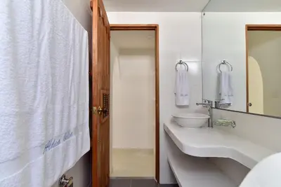 a bathroom with a sink and a toilet and a mirror at Aldea Bella Boutique in Doradal