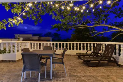 a table and chairs on a patio at night at Aldea Bella Boutique in Doradal