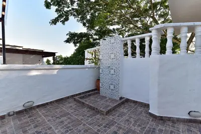 a white fence with a staircase on a house at Aldea Bella Boutique in Doradal