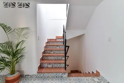 a staircase in a house with a potted plant at Aldea Bella Boutique in Doradal