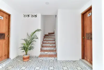 a hallway with stairs and a potted plant at Aldea Bella Boutique in Doradal