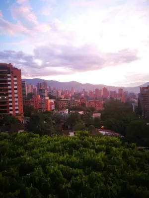 a view of a city with buildings and trees at EcoHub Hotel Medellin in Medellín