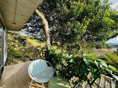 a chair sitting on the porch of a house at La Madriguera in Guatapé