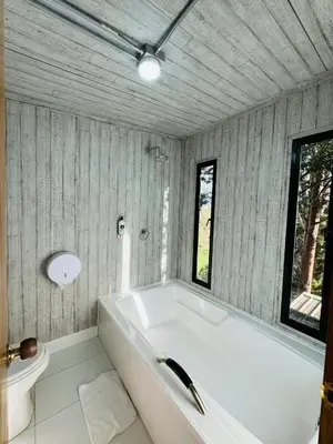a white bath tub in a bathroom with a toilet at La Madriguera in Guatapé