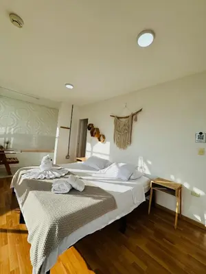 a bedroom with a bed with towels on it at La Madriguera in Guatapé