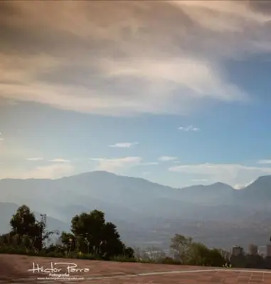 a view of a mountain range with a cloudy sky at Villa de los Angeles in Medellín