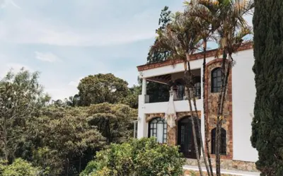 a brick house with a tree in front of it at Villa de los Angeles in Medellín