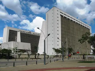 a large building in front of two tall buildings at ApartaStudio Calasanz- Cerca Estación Metro Floresta in Medellín