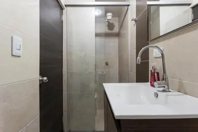a bathroom with a shower with a sink and a shower at ApartaStudio Calasanz- Cerca Estación Metro Floresta in Medellín