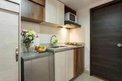a kitchen with a sink and a bowl of fruit on the counter at ApartaStudio Calasanz- Cerca Estación Metro Floresta in Medellín