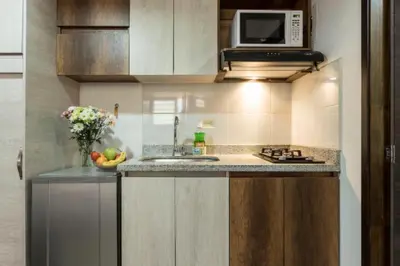 a small kitchen with a sink and a microwave at ApartaStudio Calasanz- Cerca Estación Metro Floresta in Medellín
