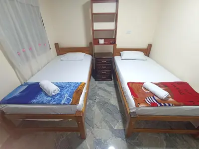 two twin beds in a room at Hotel San Vicente in Medellín