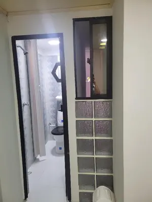 a bathroom with a toilet and a walk in closet at Hotel San Vicente in Medellín