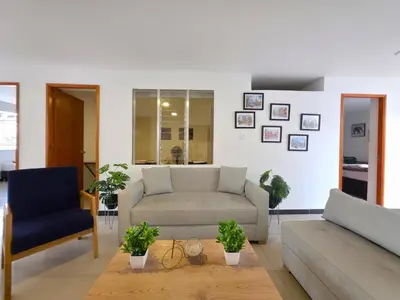 a living room with a couch and a chair at Casa amplia y cómoda cerca del Estadio y la 70 in Medellín