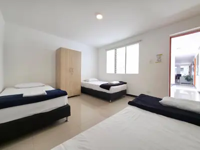 a bedroom with two beds and a window at Casa amplia y cómoda cerca del Estadio y la 70 in Medellín