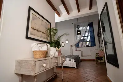 a room with a table with a plant on it at Hotel Boutique Al Alma in Santa Fe de Antioquia