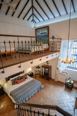 a bedroom with a bed in a room at Hotel Boutique Al Alma in Santa Fe de Antioquia