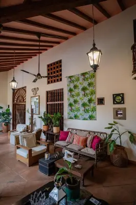 a living room with couches and tables at Hotel Boutique Al Alma in Santa Fe de Antioquia