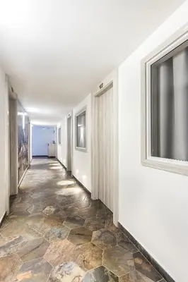 an empty hallway with a tile floor and a window at Casa Hotel Solare de la 70 in Medellín
