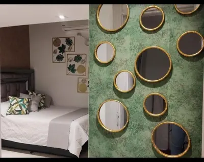 a wall with a bunch of mirrors in a bedroom at Casa Hotel Solare de la 70 in Medellín