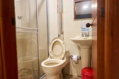 a bathroom with a shower and a toilet and a sink at Hotel el imperio in Quibdó