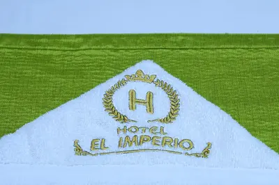 a white napkin with a hotel al imperro logo on it at Hotel el imperio in Quibdó