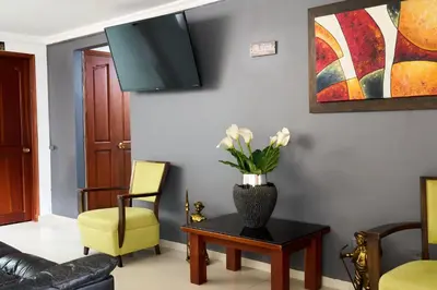 a living room with a vase of flowers on a table at Hotel el imperio in Quibdó