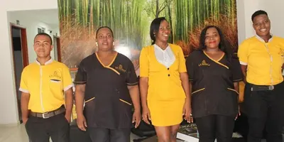 a group of people standing in front of a painting at Hotel el imperio in Quibdó