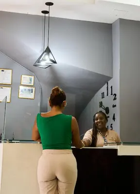 a woman looking at her reflection in a mirror at Hotel el imperio in Quibdó