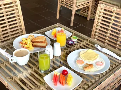 a breakfast table with plates of breakfast foods and drinks at Seven Inn Hotel in Medellín