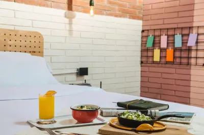 a table with a tray of food and a glass of orange juice at The Somos Beats Hotel & Rooftop in Medellín