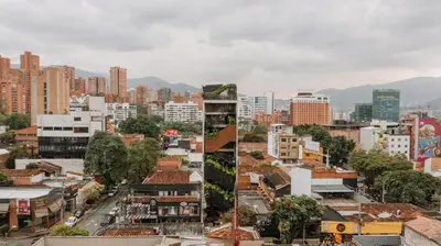 two views of a city with buildings at The Somos Beats Hotel & Rooftop in Medellín