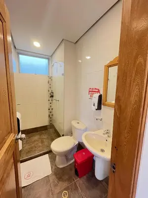 a bathroom with a toilet and a sink at Hotel Portal Central in Medellín