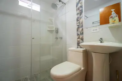 a bathroom with a toilet and a sink and a shower at 5STARHOMES - Estilo y confort en Laureles in Medellín