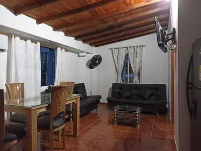 a living room with a table and a couch at El santorini colombiano cabaña in Puerto Triunfo