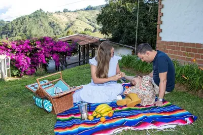 a man and a woman playing with a baby on a blanket at Mini ISABELITA in El Retiro