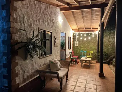 a porch with a couch and chairs on a patio at Mini ISABELITA in El Retiro