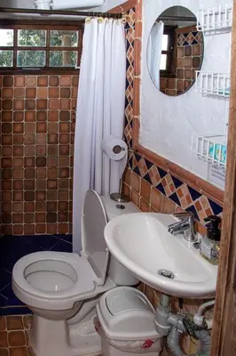 a bathroom with a toilet and a sink at Mini ISABELITA in El Retiro