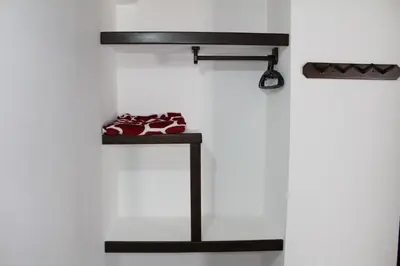 a shelf with red shoes on a white wall at Hotel La Ceiba in Valparaíso