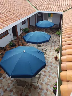 an overhead view of two blue umbrellas on a patio at Hotel La Ceiba in Valparaíso