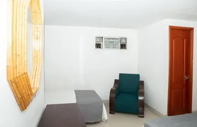 a room with a chair and a table and a window at Ayenda 1131 Casa Valencia in Manizales