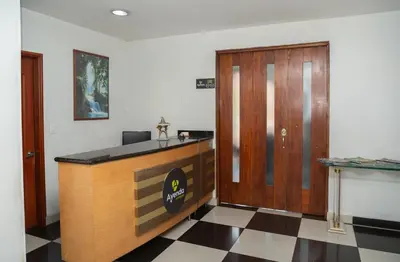 a law office with a desk and a wooden door at Ayenda 1131 Casa Valencia in Manizales