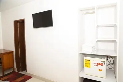 a room with a white wall with a tv on the wall at Ayenda 1131 Casa Valencia in Manizales