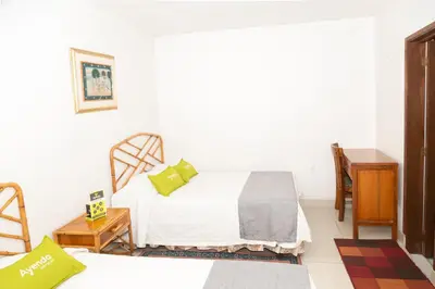 a bedroom with a bed and a table and a desk at Ayenda 1131 Casa Valencia in Manizales