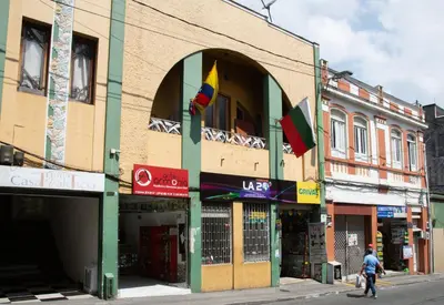 a man walking down a street in front of a building at Ayenda 1131 Casa Valencia in Manizales