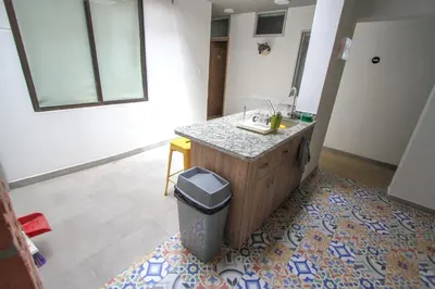 a kitchen with a counter and a trash can at Casa Tuvia in Medellín