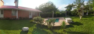 a house with a yard with a swimming pool at La Luna by JR in Mariquita