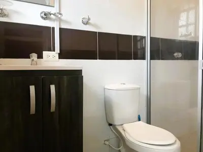 a bathroom with a toilet and a sink at La Luna by JR in Mariquita