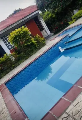 a swimming pool in front of a house at La Luna by JR in Mariquita