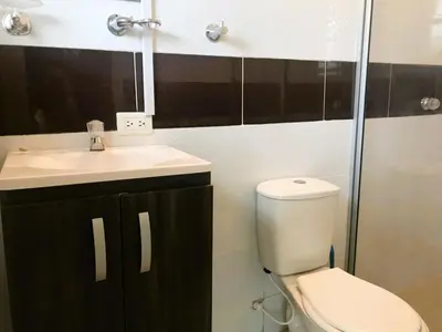 a bathroom with a toilet and a sink at La Luna by JR in Mariquita